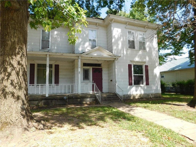 420 N Washington St, Nevada, MO 64772 - view of front of property featuring a porch and a front yard