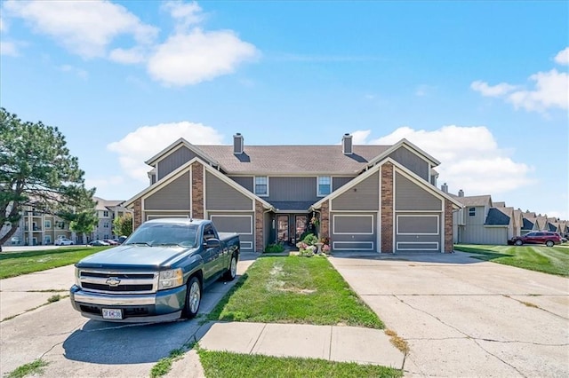 518 NE 6th St Unit A, Blue Springs, MO 64014 - view of front of home with brick siding, concrete driveway, a front yard, and a garage