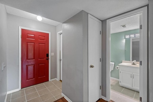 518 NE 6th St Unit A, Blue Springs, MO 64014 - foyer featuring a textured ceiling and light tile patterned floors