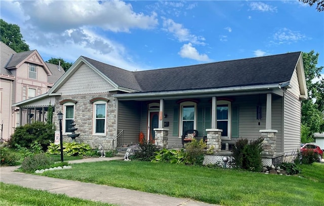 303 W Clay Ave, Plattsburg, MO 64477 - view of front facade with covered porch, a front yard, and stone siding