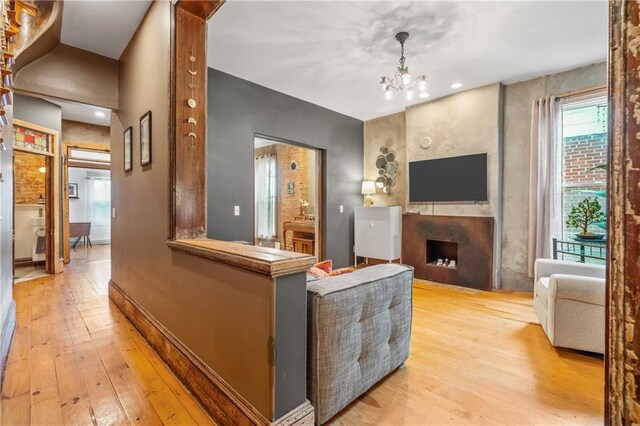 1637 Jefferson St, Kansas City, MO 64108 - living area featuring light wood-type flooring, a fireplace, and a chandelier
