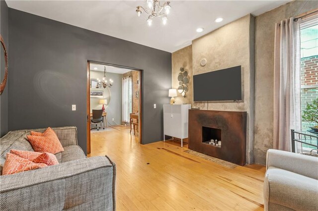 1637 Jefferson St, Kansas City, MO 64108 - living area featuring a chandelier, wood finished floors, and a fireplace