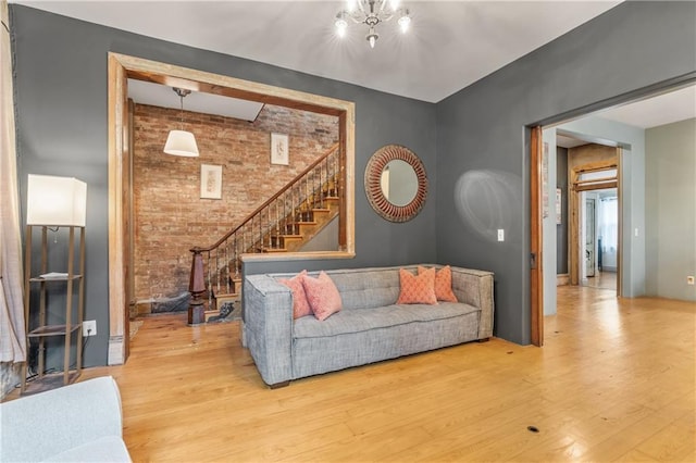 1637 Jefferson St, Kansas City, MO 64108 - living area featuring brick wall, light wood-style flooring, stairway, and an accent wall