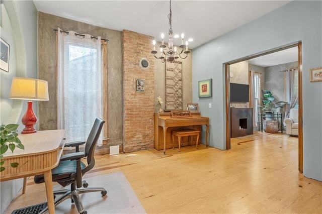 1637 Jefferson St, Kansas City, MO 64108 - office area featuring light wood-type flooring and a chandelier