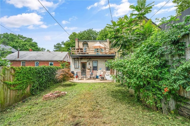 1637 Jefferson St, Kansas City, MO 64108 - back of house with a balcony, a patio, and stucco siding