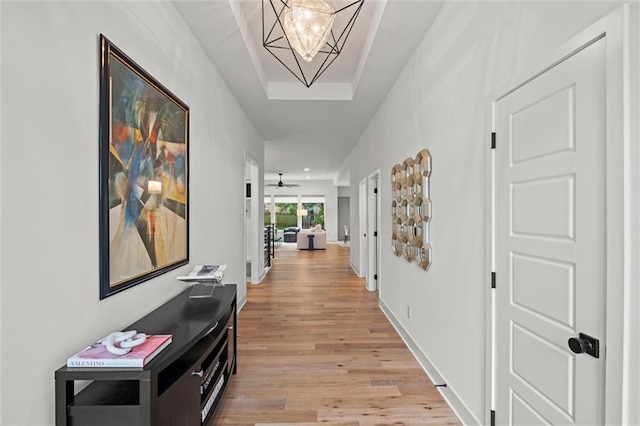 1213 NE Goshen Dr, Lees Summit, MO 64064 - corridor with light wood-style floors and a chandelier