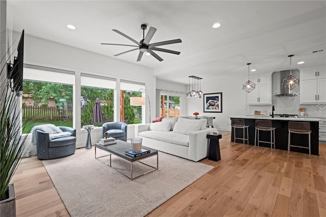 1213 NE Goshen Dr, Lees Summit, MO 64064 - living area featuring a ceiling fan, recessed lighting, and light wood-style flooring