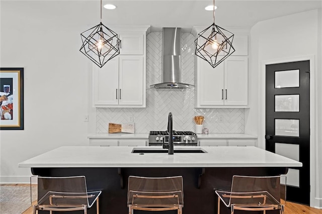 1213 NE Goshen Dr, Lees Summit, MO 64064 - kitchen featuring wall chimney exhaust hood, backsplash, a breakfast bar, light countertops, and hanging light fixtures