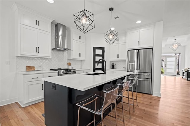 1213 NE Goshen Dr, Lees Summit, MO 64064 - kitchen featuring appliances with stainless steel finishes, wall chimney exhaust hood, light countertops, light wood-style flooring, and white cabinetry