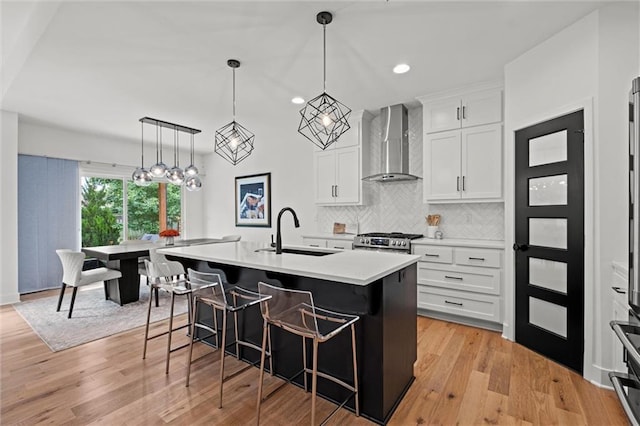 1213 NE Goshen Dr, Lees Summit, MO 64064 - kitchen featuring wall chimney range hood, a breakfast bar area, light countertops, tasteful backsplash, and white cabinets