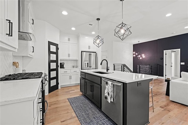 1213 NE Goshen Dr, Lees Summit, MO 64064 - kitchen with stainless steel appliances, a breakfast bar area, white cabinets, wall chimney exhaust hood, and recessed lighting