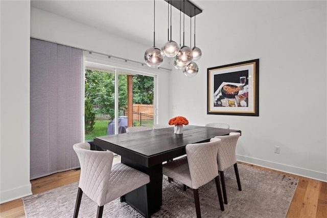 1213 NE Goshen Dr, Lees Summit, MO 64064 - dining area with wood finished floors and a chandelier