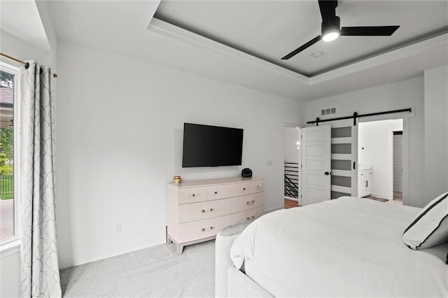 1213 NE Goshen Dr, Lees Summit, MO 64064 - bedroom featuring a barn door, a raised ceiling, carpet floors, and ceiling fan