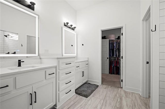 1213 NE Goshen Dr, Lees Summit, MO 64064 - full bathroom featuring vanity, a walk in closet, marble look tile flooring, and tiled shower