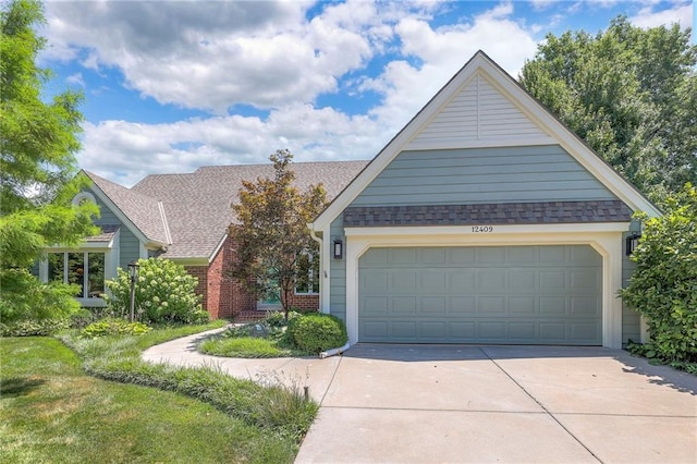 12409 Cambridge Cir, Leawood, KS 66209 - view of front of home featuring driveway, an attached garage, and a shingled roof