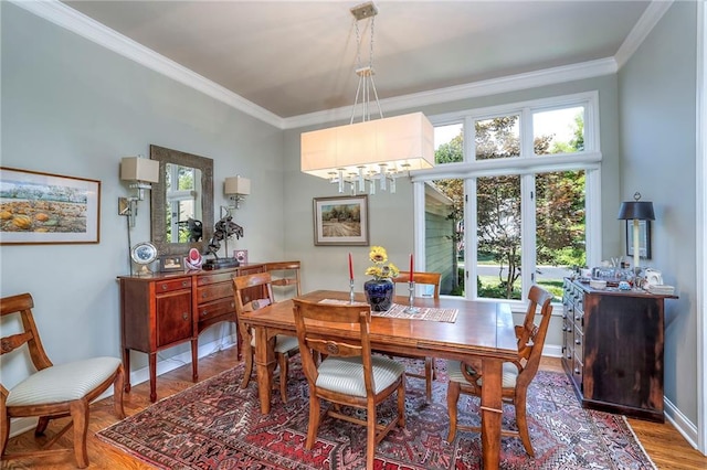 12409 Cambridge Cir, Leawood, KS 66209 - dining space featuring ornamental molding, a chandelier, and wood finished floors