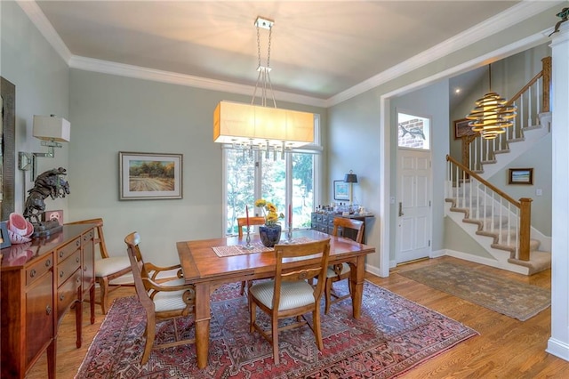 12409 Cambridge Cir, Leawood, KS 66209 - dining space with stairway, light wood-style flooring, and ornamental molding
