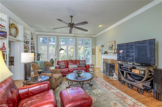 12409 Cambridge Cir, Leawood, KS 66209 - living area with ceiling fan, ornamental molding, a fireplace with flush hearth, wood finished floors, and recessed lighting