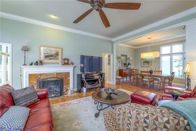 12409 Cambridge Cir, Leawood, KS 66209 - living area with wood finished floors, a ceiling fan, a fireplace, and crown molding
