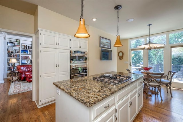 12409 Cambridge Cir, Leawood, KS 66209 - kitchen featuring stainless steel gas cooktop, wood finished floors, stone counters, a chandelier, and recessed lighting