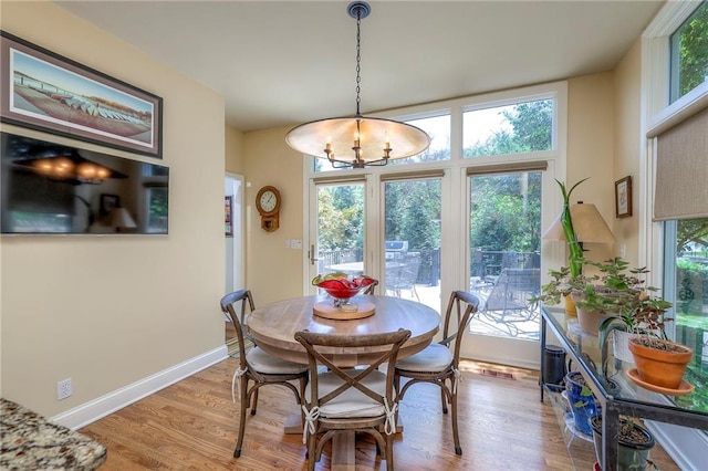 12409 Cambridge Cir, Leawood, KS 66209 - dining area with a chandelier and light wood-style flooring