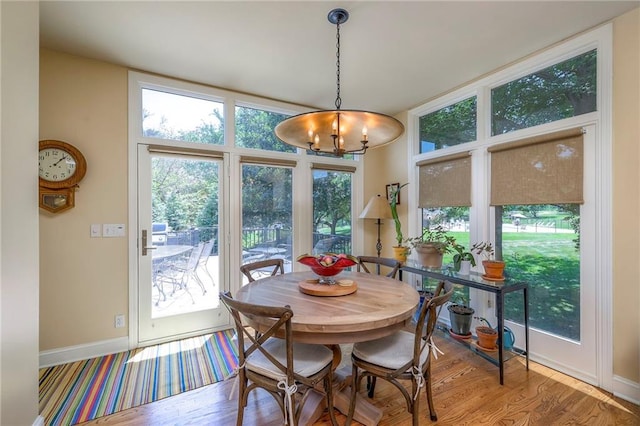 12409 Cambridge Cir, Leawood, KS 66209 - dining area with a chandelier and wood finished floors