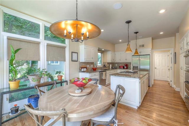 12409 Cambridge Cir, Leawood, KS 66209 - dining room featuring a chandelier, light wood-type flooring, and recessed lighting
