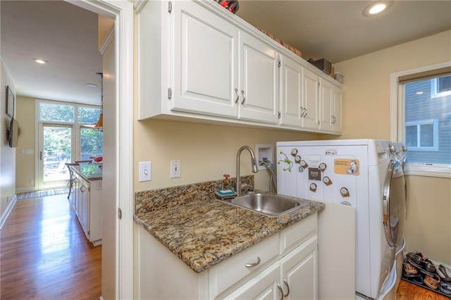 12409 Cambridge Cir, Leawood, KS 66209 - washroom with cabinet space, light wood-style flooring, washing machine and clothes dryer, and recessed lighting