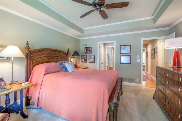 12409 Cambridge Cir, Leawood, KS 66209 - bedroom with a tray ceiling, crown molding, light carpet, ensuite bathroom, and ceiling fan