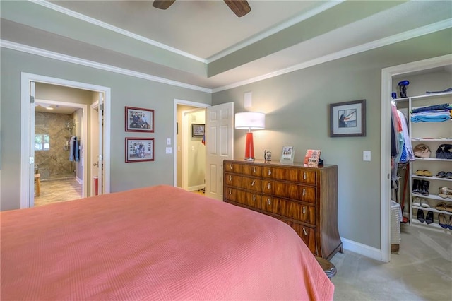 12409 Cambridge Cir, Leawood, KS 66209 - bedroom with a walk in closet, carpet floors, a raised ceiling, crown molding, and a ceiling fan
