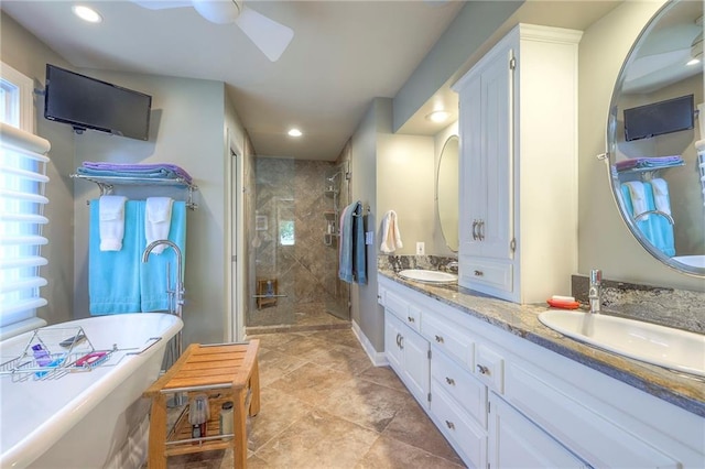 12409 Cambridge Cir, Leawood, KS 66209 - bathroom featuring double vanity, a stall shower, a freestanding tub, recessed lighting, and a ceiling fan