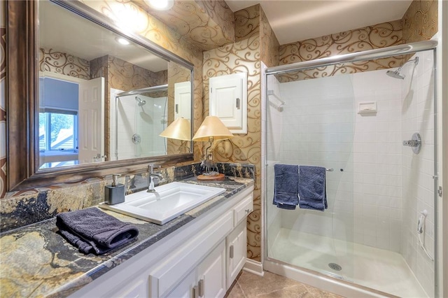 12409 Cambridge Cir, Leawood, KS 66209 - full bathroom featuring a stall shower, vanity, wallpapered walls, and tile patterned floors