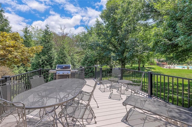 12409 Cambridge Cir, Leawood, KS 66209 - wooden deck with outdoor dining area, a yard, and area for grilling