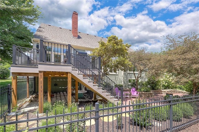 12409 Cambridge Cir, Leawood, KS 66209 - rear view of house with stairs, a chimney, a deck, and a shingled roof