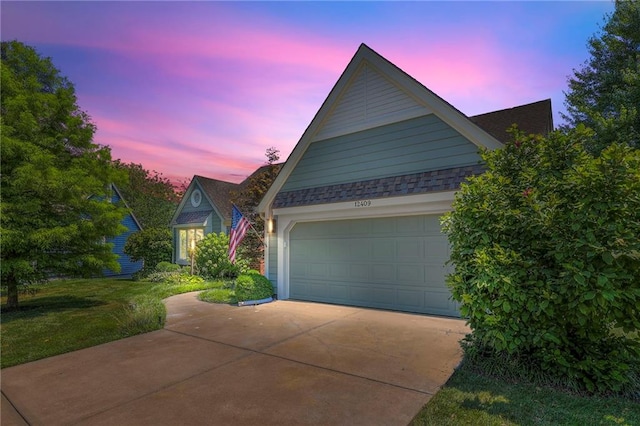 12409 Cambridge Cir, Leawood, KS 66209 - view of front of property with concrete driveway, an attached garage, and a lawn