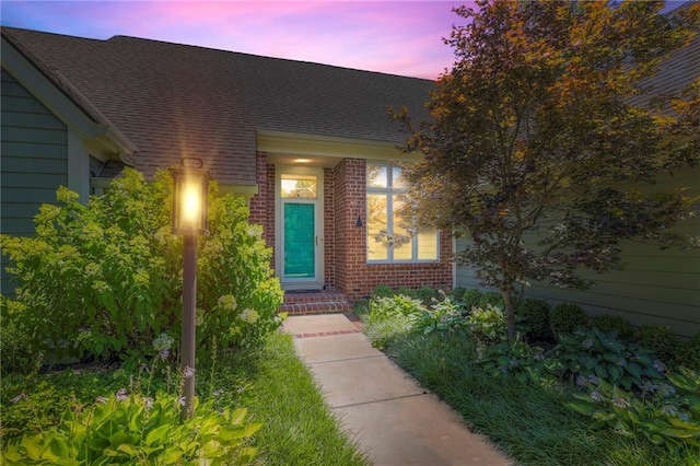 12409 Cambridge Cir, Leawood, KS 66209 - property entrance with brick siding and a shingled roof