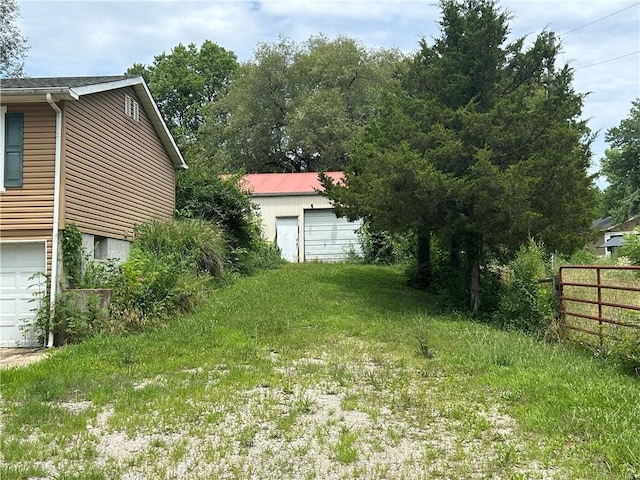 34908 E Shores Rd, Lone Jack, MO 64070 - view of yard with a garage