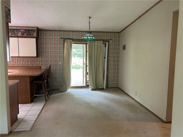 34908 E Shores Rd, Lone Jack, MO 64070 - unfurnished dining area featuring wallpapered walls, light carpet, a textured ceiling, and ornamental molding