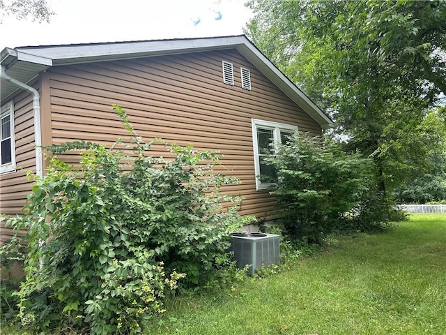 34908 E Shores Rd, Lone Jack, MO 64070 - view of property exterior with a central AC unit and a yard