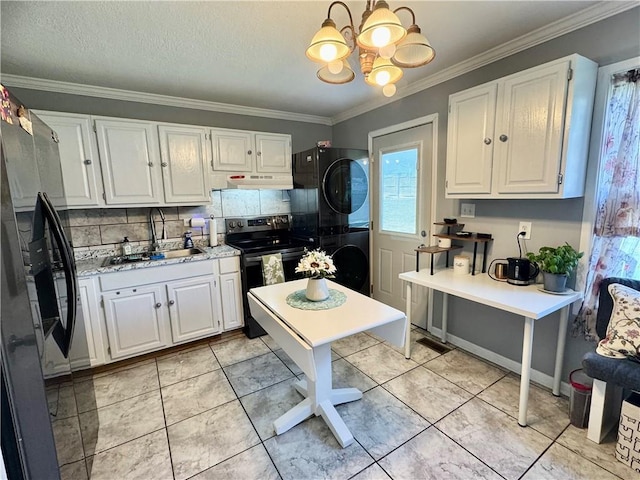609 N 83rd Ter, Kansas City, KS 66112 - kitchen featuring stacked washer / dryer, refrigerator with ice dispenser, stainless steel electric stove, under cabinet range hood, and a chandelier