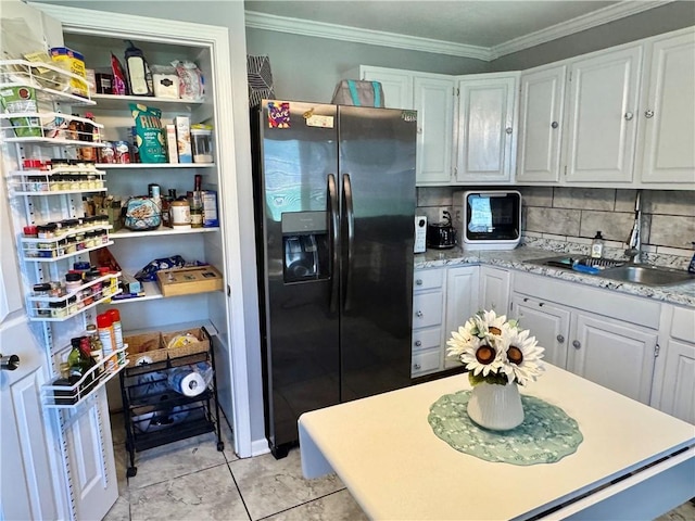 609 N 83rd Ter, Kansas City, KS 66112 - kitchen with refrigerator with ice dispenser, crown molding, tasteful backsplash, and white cabinetry