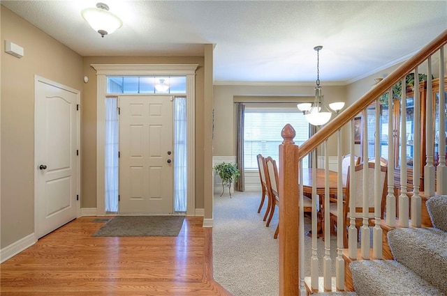 1105 Blazing Star Dr, Lees Summit, MO 64081 - entryway with a chandelier, stairway, light wood-type flooring, and crown molding