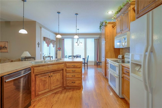 1105 Blazing Star Dr, Lees Summit, MO 64081 - kitchen featuring white appliances, light wood-style flooring, light countertops, and decorative light fixtures