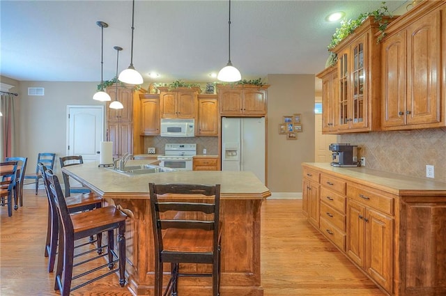 1105 Blazing Star Dr, Lees Summit, MO 64081 - kitchen featuring white appliances, light wood-type flooring, glass insert cabinets, and decorative backsplash