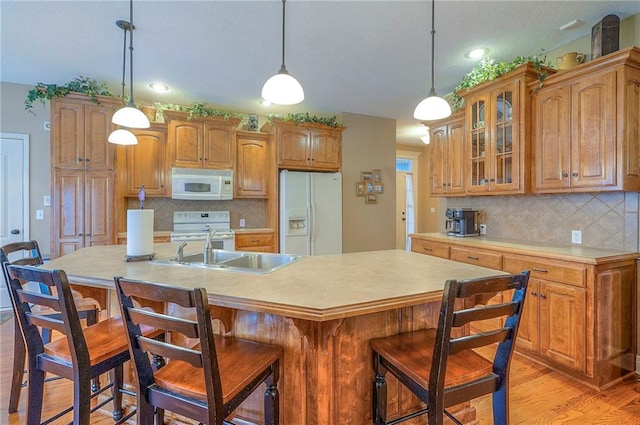1105 Blazing Star Dr, Lees Summit, MO 64081 - kitchen featuring white appliances, light wood-style flooring, glass insert cabinets, decorative backsplash, and light countertops