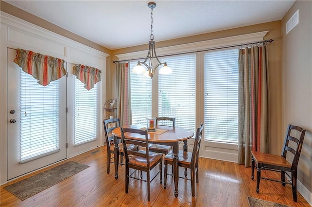 1105 Blazing Star Dr, Lees Summit, MO 64081 - dining area featuring a chandelier and light wood-type flooring
