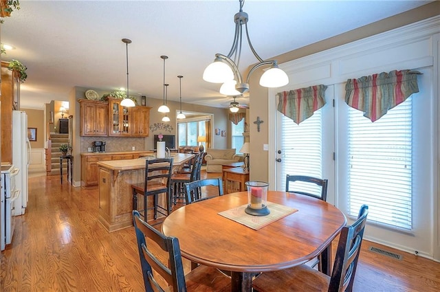 1105 Blazing Star Dr, Lees Summit, MO 64081 - dining room with healthy amount of natural light, light wood-type flooring, and a ceiling fan