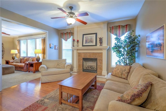 1105 Blazing Star Dr, Lees Summit, MO 64081 - living area with a ceiling fan, wood finished floors, a tile fireplace, and crown molding