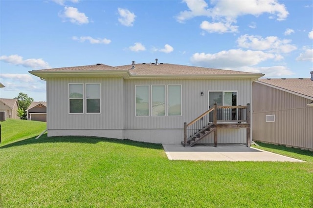 12421 Meadow Ln, Kansas City, KS 66109 - back of property featuring a patio area and a lawn