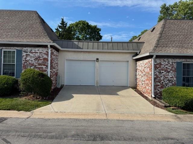 5737 Metcalf Ct, Overland Park, KS 66202 - view of property exterior featuring an attached garage, a shingled roof, driveway, and brick siding